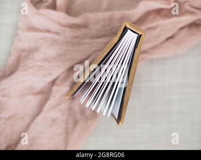 top view of brown leather photo album pages on pink linen Stock Photo