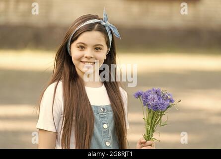 Little girl cornflowers bouquet holiday greetings, birthday gift concept Stock Photo