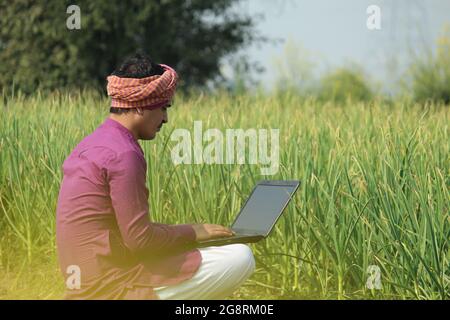 farmer,indian farmer,using laptop in agricultural field Stock Photo