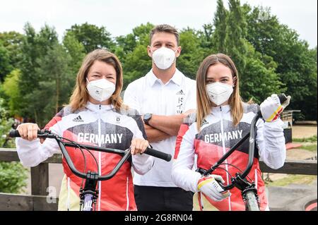 Berlin, Germany. 22nd July, 2021. Lara Lessmann (r) and Rebecca Berg (l), BMX professional athletes, and Tobias Wicke, national coach for BMX freestyle, stand in Mellowpark shortly before leaving for Tokyo. BMX freestyle is an Olympic discipline for the first time this year. Credit: Kira Hofmann/dpa-Zentralbild/ZB/dpa/Alamy Live News Stock Photo
