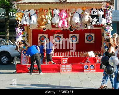 SHEFFIELD. SOUTH YORKSHIRE. ENGLAND. 07-10-21. Barker's Pool in the city centre. A fairground archery stall closing down for the day.