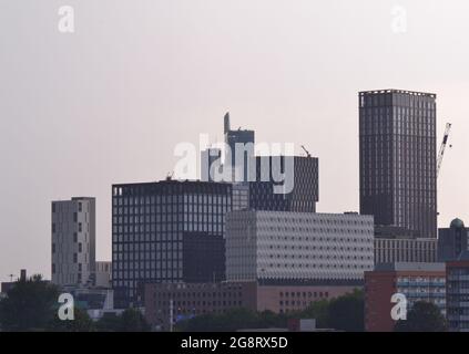 Manchester, UK. 22nd July, 2021. UK Weather: Thunder clouds and whispers of thunder at dusk in Manchester, England, UK, as the heatwave continues. High level view of new skyscrapers in central Manchester. Credit: Terry Waller/Alamy Live News Stock Photo