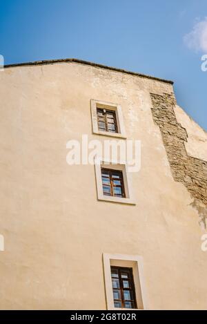 Low angle view of the building with beige walls and windows with a ruined part on a sunny day Stock Photo