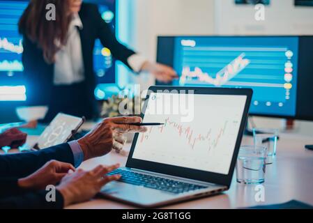 Crop businesspeople analyzing graph during meeting Stock Photo