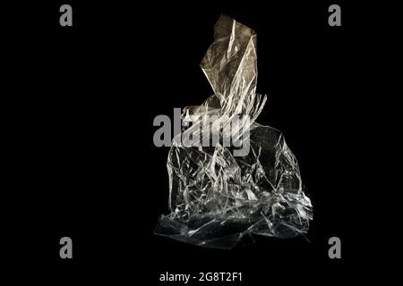 plastic foil from a disposable bag shown like an art sculpture against a black background, packaging waste of abundance and throwaway society, consume Stock Photo
