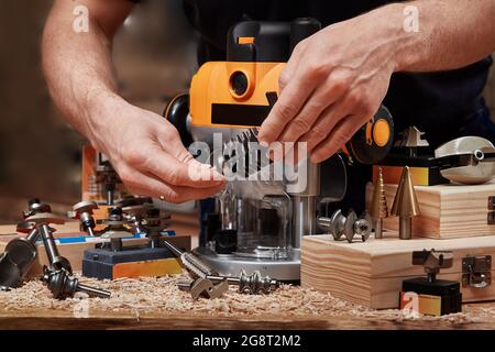 Milling wood in the joinery using manual mechanical cutters Stock Photo