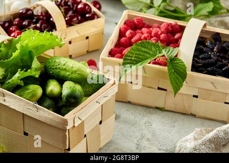 Harvest vegetables in wooden basket on light background Stock Photo