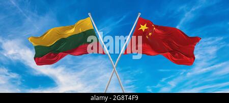 flags of China and LITHUANIA  waving in the wind on flagpoles against sky with clouds on sunny day. Symbolizing relationship, dialog between two count Stock Photo