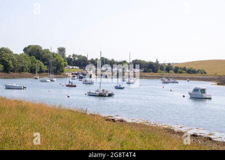 21 July 2021 Pleasure boats moored in the calm waters at the National Trust property at Gibbs Island near Killyleagh in County Down Northern Ireland. Stock Photo