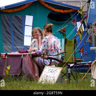 Woman having a tarot card reading at an outdoor festival Stock Photo