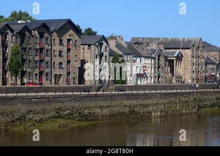 View across River Lune in Lancaster to historic buildings including Maritime Museum and converted old warehouses on St George's Quay, 17th July 2021. Stock Photo