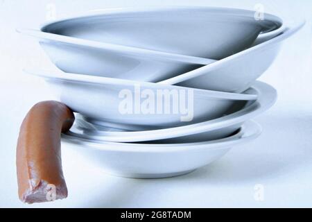 stack of dirty plates with sausage Stock Photo