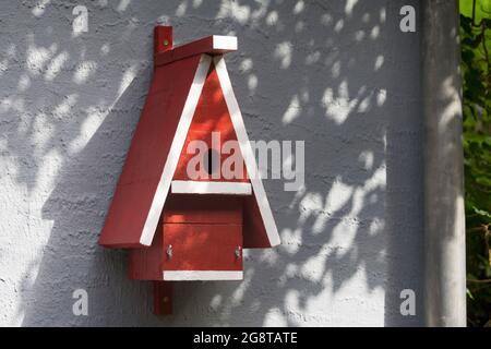 self-made nesting box for birds at a house wall, Germany Stock Photo