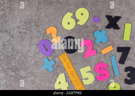 School stationary and numbers on grey background. Top view. Stock Photo