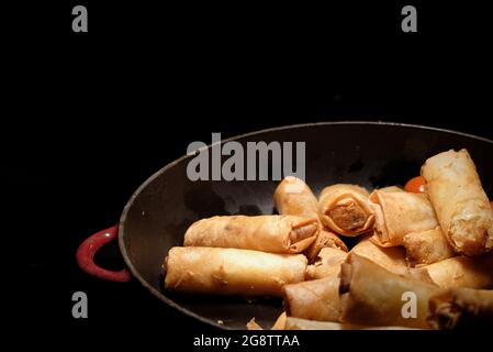 deep fried spring rolls  surve on the pan in dark background Stock Photo