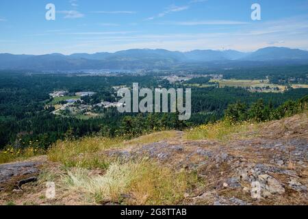 View of Port Alberni and Vancouver Island's Alberni Valley from rock outcropping at summit of Alberni Lookout. Stock Photo