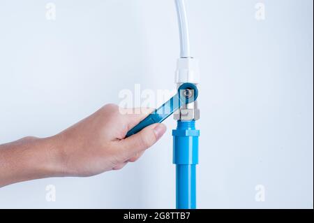 hand with pipe and valve Stock Photo