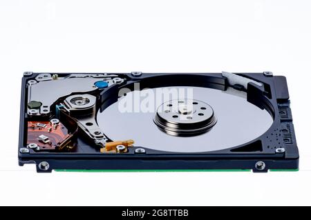 a computer's hard disk hdd data storage drive without shield show magnetic disc and electronic part inside isolated  in white background Stock Photo