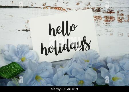 Hello Holiday Card with Blooming flower on wooden background Stock Photo