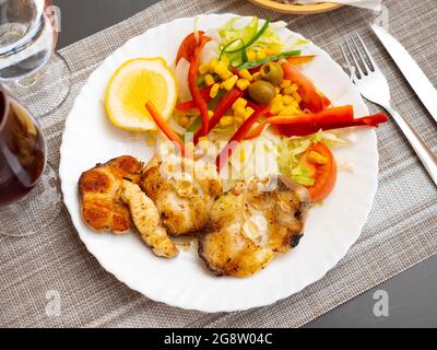 Oven baked hake with vegetable garnish Stock Photo