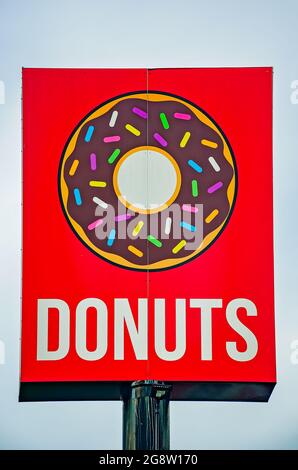 A sign advertises donuts at Lickin Good Donuts, July 18, 2021, in Mobile, Alabama. The restaurant specializes in doughnuts and kolaches. Stock Photo