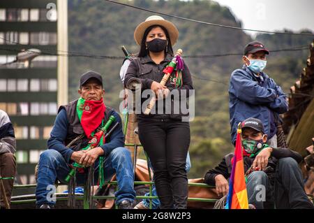 Members of the indigenous guard sit on a traditional bus during the demonstration.The indigenous guard arrives in Bogotá on July 20th, Colombia's Independence Day, to support the protests. The day began with a press conference in front of the CRIC (Cauca Regional Indigenous Council), where also members of the frontline participated, during the day two traditional buses, that the indigenous groups used for transport drove all over the resistance points of the capital, where the protests were taking place. Credit: SOPA Images Limited/Alamy Live News Stock Photo