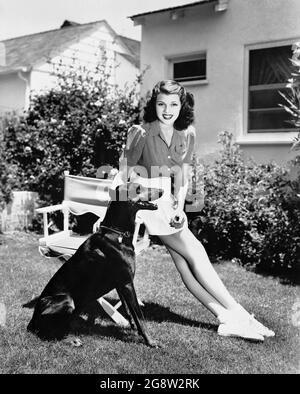 RITA HAYWORTH with Doberman Pinscher Dog circa 1939 candid portrait publicity for Columbia Pictures Stock Photo