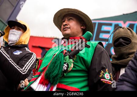 Representative of the indigenous guard together with members of the front line are seen during the rally.The indigenous guard arrives in Bogotá on July 20th, Colombia's Independence Day, to support the protests. The day began with a press conference in front of the CRIC (Cauca Regional Indigenous Council), where also members of the frontline participated, during the day two traditional buses, that the indigenous groups used for transport drove all over the resistance points of the capital, where the protests were taking place. Credit: SOPA Images Limited/Alamy Live News Stock Photo