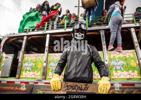 Members of the indigenous guard sit on a traditional bus during the demonstration.The indigenous guard arrives in Bogotá on July 20th, Colombia's Independence Day, to support the protests. The day began with a press conference in front of the CRIC (Cauca Regional Indigenous Council), where also members of the frontline participated, during the day two traditional buses, that the indigenous groups used for transport drove all over the resistance points of the capital, where the protests were taking place. (Photo by Antonio Cascio/SOPA Images/Sipa USA) Credit: Sipa USA/Alamy Live News Stock Photo