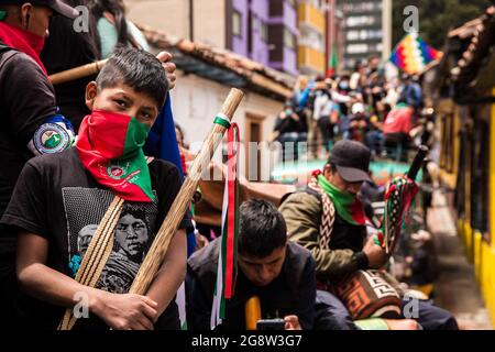 Members of the indigenous guard are seen during the demonstration.The indigenous guard arrives in Bogotá on July 20th, Colombia's Independence Day, to support the protests. The day began with a press conference in front of the CRIC (Cauca Regional Indigenous Council), where also members of the frontline participated, during the day two traditional buses, that the indigenous groups used for transport drove all over the resistance points of the capital, where the protests were taking place. (Photo by Antonio Cascio/SOPA Images/Sipa USA) Credit: Sipa USA/Alamy Live News Stock Photo