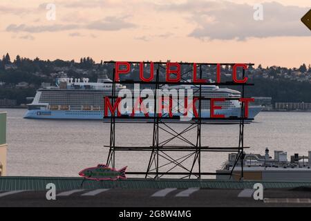 Seattle, USA. 21 Jul, 2021. Royal Caribbean Ovation of the Seas cruise ship and the Pike Place Market neon sign. Stock Photo