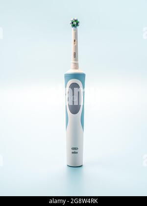 Russia, Moscow, july 22, 2021: Braun Oral-B toothbrush head Cross Action. modern electric toothbrush on light blue background. vertical Stock Photo