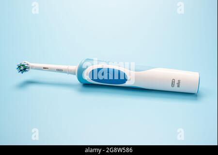 Russia, Moscow, july 22, 2021: Braun Oral-B toothbrush head Cross Action lies on blue background. modern electric toothbrush on light blue background. Stock Photo