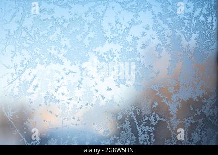 frosty patterns on window. Frosty Patterns On The Window Glass Closeup. Winter background. Blue Frost Background, Closeup Frozen Winter Window Pane Co Stock Photo