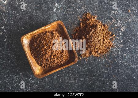 Cocoa powder in wooden bowl. Top view. Stock Photo