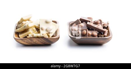 White and dark nutty chocolate with hazelnuts in bowl isolated on white background. Stock Photo