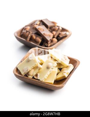 White and dark nutty chocolate with hazelnuts in bowl isolated on white background. Stock Photo