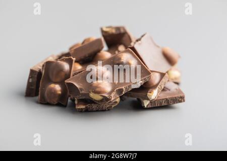 Nutty chocolate with hazelnuts on gray background. Stock Photo