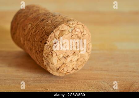 One champagne cork is lying on a wooden table. Close up. Macro.  Stock Photo