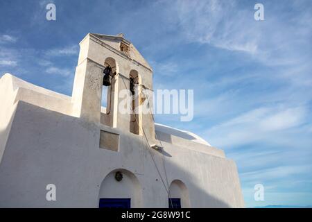 Church orthodox, small whitewashed old chapel, climbed on rocky mountain at Serifos island over Chora, Cyclades Greece. Blue cloudy sky background. Su Stock Photo