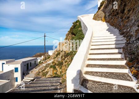 Serifos island, Cyclades Greece. Stone stairs on rocky mountain over Chora, sunny day. Blue sky and sea background. Greek landscape, vacation relax hi Stock Photo