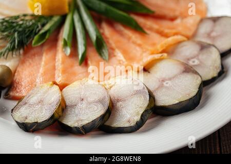 Assorted smoked fish platter on wooden background Stock Photo