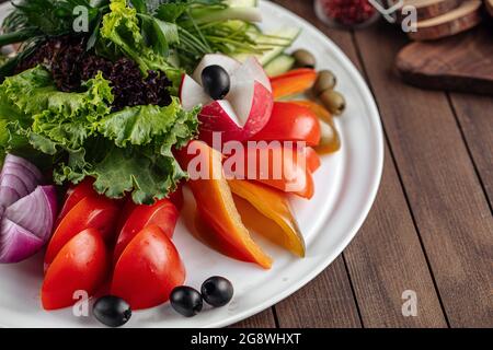 Fresh vegetables platter with greens  Stock Photo