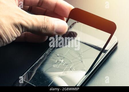 closeup broken tempered glass screen protector for smartphone. Stock Photo