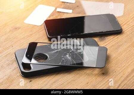 closeup broken tempered glass screen protector for smartphone. Stock Photo