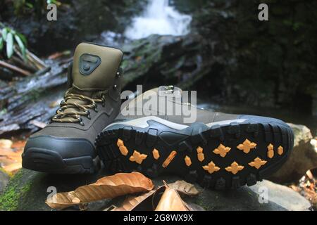 boots with a masculine design for outdoor adventure activities, with jagged soles suitable for tropical and snowy terrain. Stock Photo