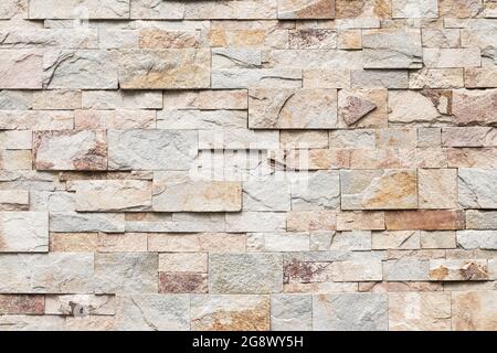 Old brick wall texture, abstract stone background. Urban brickwall, uneven rough stonewall. Beige tile, granite Stock Photo