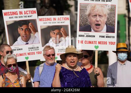 Campaigners hold placards of Prime Minister Boris Johnson and Chancellor Rishi Sunak during a demonstration organised by the Climate Coalition in Parliament Square, London, to mark 100 days to go until the Cop26 climate summit in Glasgow. Picture date: Friday July 23, 2021. Stock Photo