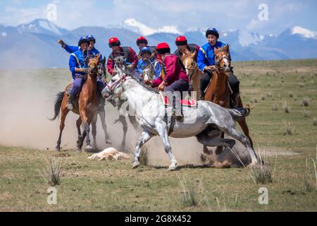 Nomad horse riders playing traditional horse game of Buzkashi known also as Kokpar, in Issyk Kul, Kyrgyzstan. Stock Photo