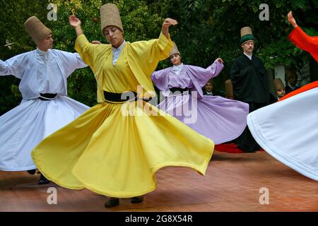 Whirling dervishes during Sufi whirling ritual performance known as Sema, in Istanbul, Turkey Stock Photo